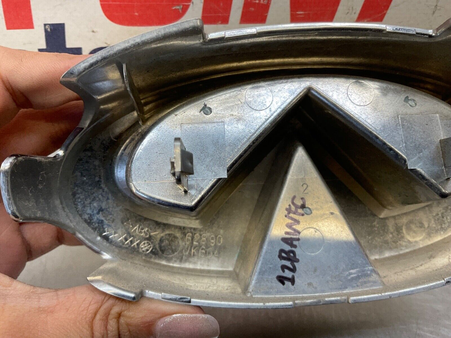 2009 Infiniti V36 G37 Front Grille Emblem  OEM 12BAWFC - On Point Parts Inc